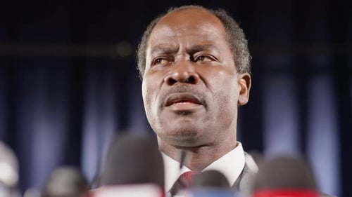 Black Politician Speaking in Microphones at Press Conference