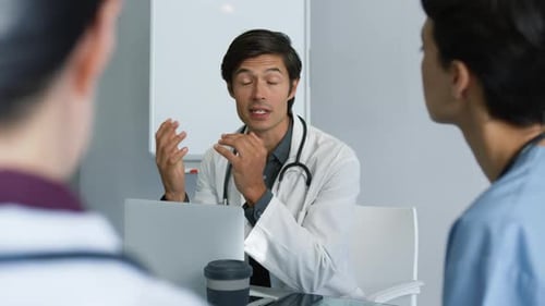 Doctors Meeting for Collaboration in Modern Hospital Office