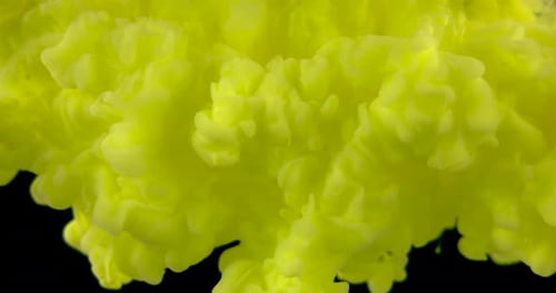 Swirling Yellow Ink Cloud on Black Background