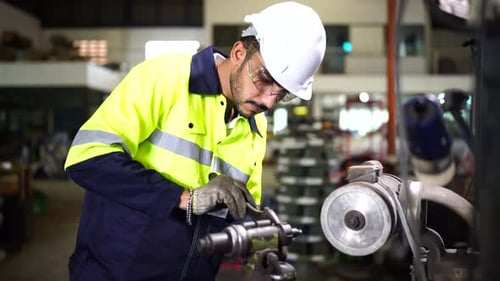 Factory Worker is Setting Up CNC Lathe Machine