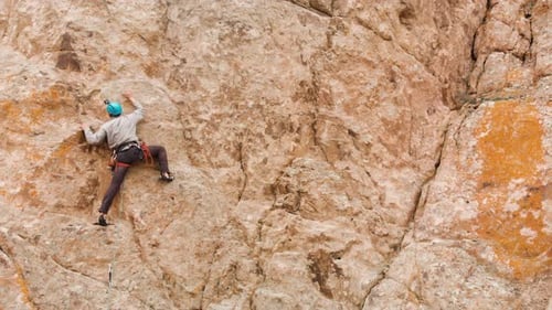 Man Athlette Climbing on the High Rock