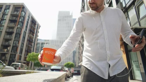 Man Using Phone in Urban City Setting