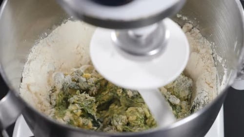 Dough Being Mixed in a Metal Bowl