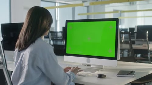 Business Woman Working In Office Interior On Pc On Desk Looking At Display Green Screen