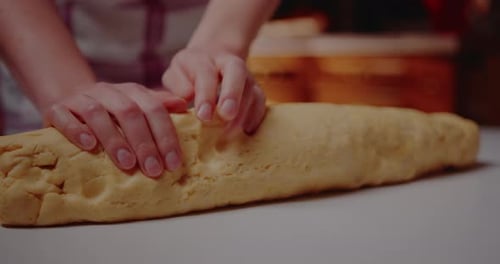 Hands Rolling Dough for Baking Preparation