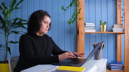 Middle Aged Older Woman Working or Social Distance Learning From Home
