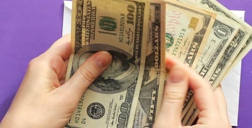 Hands Count and Place Cash into White Envelope