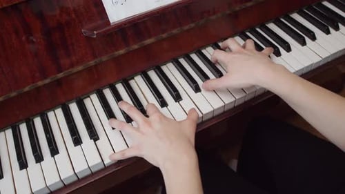 Hands Play Wooden Piano Keys