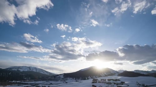 Time lapse of the sun setting behind Colorado mountains during the winter