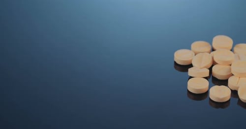 Collection of Round Pills Piling Up on Surface