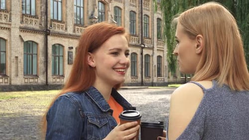 Two Friends Chatting on College Campus with Coffee