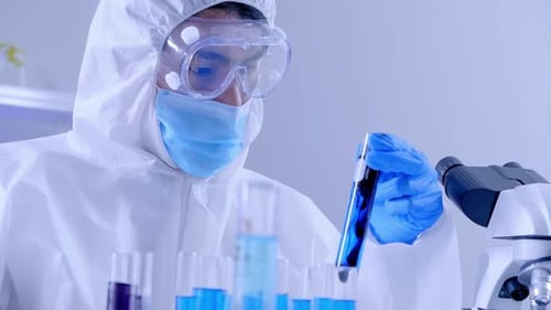Scientist Mixing Chemicals in Laboratory Test Tube