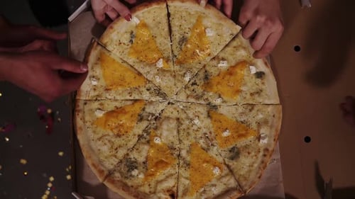 Top View of Hands Adults Taking Pizza Slices From Cardboard Box