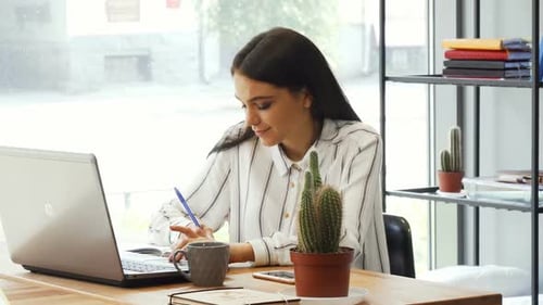 Young Businesswoman Enjoying Working at Her Office