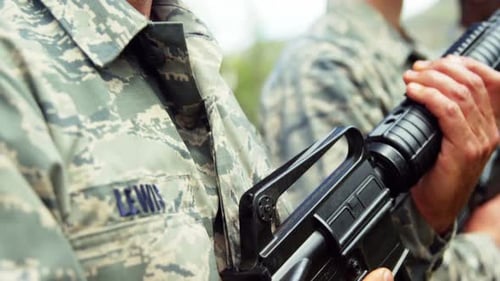 Soldiers Holding Weapons in an Outdoor Rural Setting