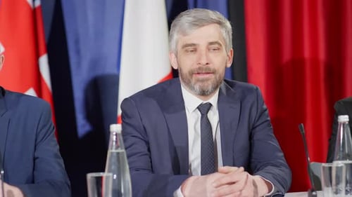 Adults Speaking at a Press Conference at a Table
