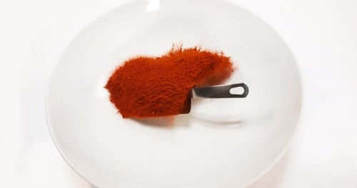 Paprika, capsicum annuum, Powder falling against White Background, Slow Motion 4K
