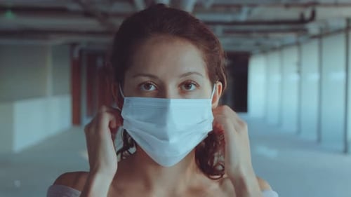 Portrait of a Young Woman Wearing Protective Medical Face Mask