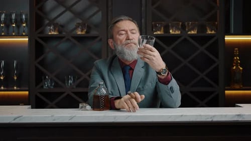 Elegant Man Enjoys Whiskey and Cigar at Bar