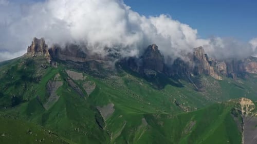 Aerial View of Majestic Mountains and Clouds