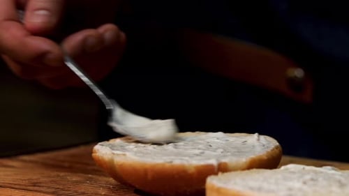 Spreading Creamy Sauce on a Hamburger Bun