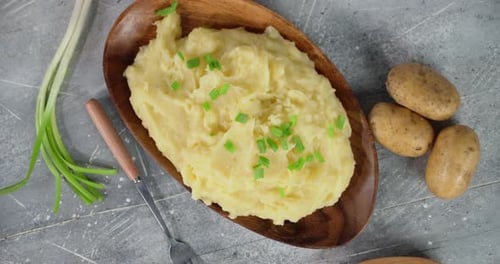 Overhead of Mashed Potatoes on Wooden Plate