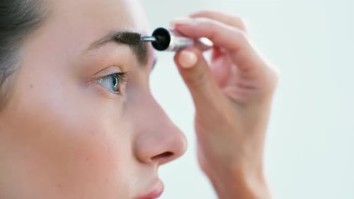 Woman Styles Eyebrow With Wand Close Up