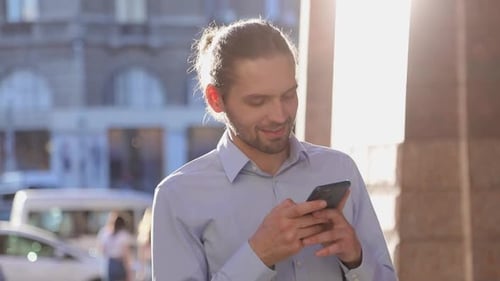 Business Man Using Mobile Phone On Street On Sunny Day