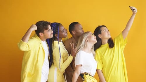 Beautiful Men and Women in Yellow Outfit Are Friends, Take Photo Together