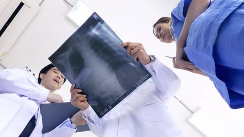 Medical Team Examining Chest X-ray in Hospital