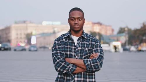 Confident Young Adult Standing in Urban Landscape