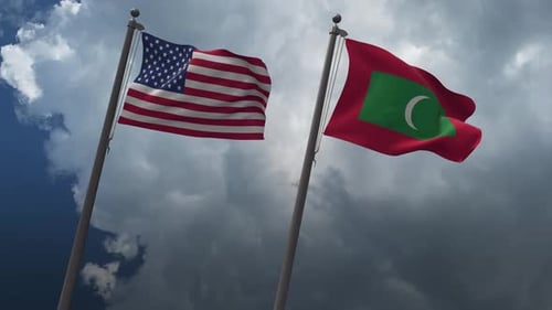 United States and Maldives National Flags Waving on Flagpoles