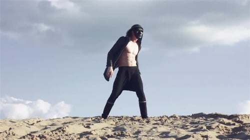 Man in Black Mask in Desert