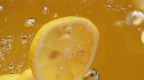 Lemon Slices Falling into Water
