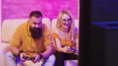 Couple Having Fun Playing Video Games at Home