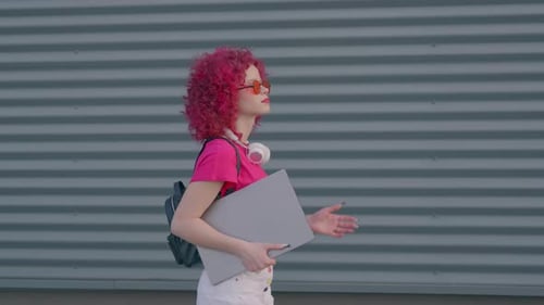 A Pink Curly Woman is Walking to Work or College