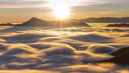 Mountains Through the Clouds at Golden Sunrise