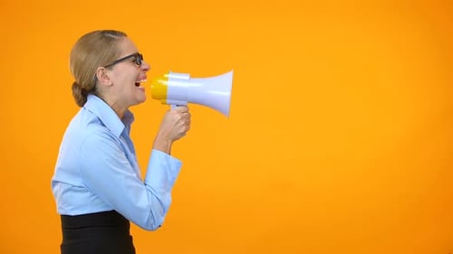 Woman Yelling into Megaphone on Orange Background