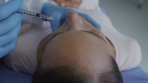 Woman Receives Forehead Injection in Hospital Close Up