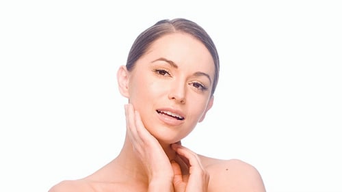 Smiling Woman Touching Her Face on White Background