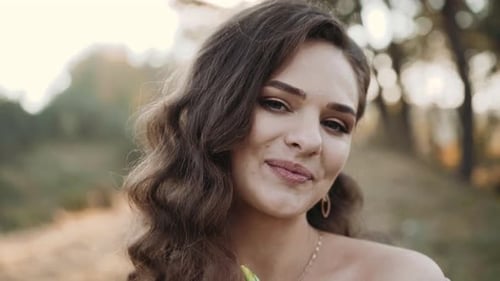 Beautiful Woman with Flowers Smiling in Nature