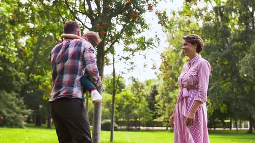 Happy Family Playing at Summer Park