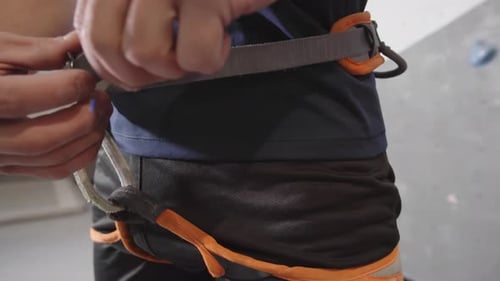 Man Putting on Climbing Belaying