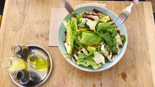 Overhead Shot of Person Cutting a Salad