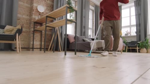 Man Mopping and Dancing on Hardwood Floor