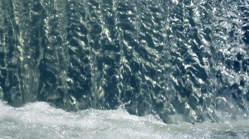 Water Cascading Over Mini Waterfall Outdoors