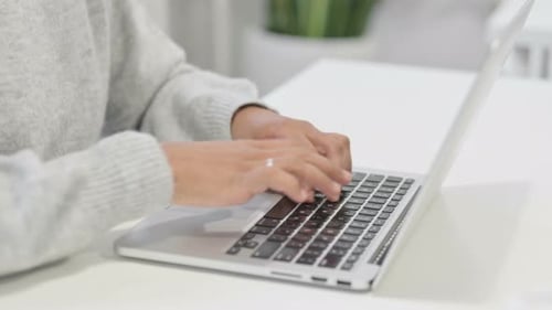 Close Up of Hands of African Woman Working on Laptop