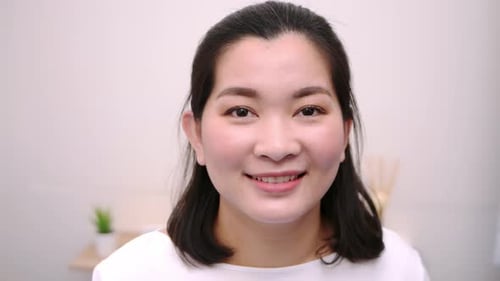 Smiling Woman's Portrait in a Bright Indoor Setting