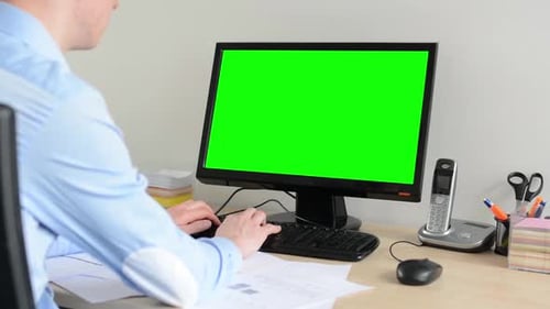 Man Works on Desktop Computer in the Office - Green Screen