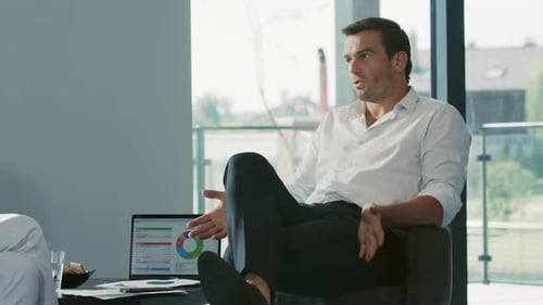 Business Meeting in Office with Financial Charts